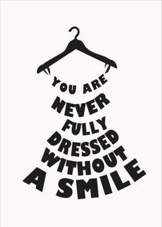 a dress hanging on a hanger with the words you are never fully dressed without a smile