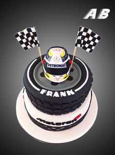 a birthday cake with a racing helmet on top and checkered flags sticking out of it