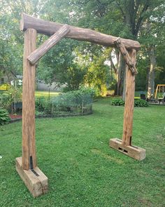 two wooden structures sitting on top of a lush green field