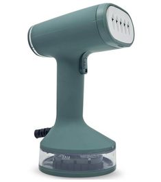 an electric hair dryer sitting on top of a white table next to a light