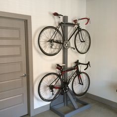 a bicycle is mounted to a pole in the corner of a room with two doors