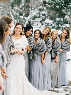 a group of women standing next to each other in the snow