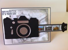 a birthday card with a camera attached to the back of it and some pictures on the front