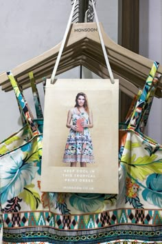 a woman's dress hanging on a hanger with an advertise for the women's clothing brand