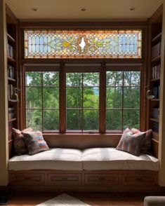 a window seat in front of a stained glass window