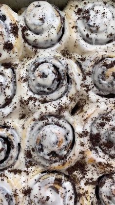 an overhead view of cinnamon rolls covered in icing