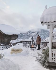 a man standing on top of a snow covered roof