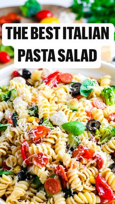 a pasta salad in a white bowl on a table