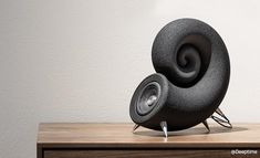 a speaker sitting on top of a wooden table