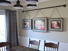 three pictures hanging on the wall above a dining room table with chairs and a bench