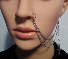 a mannequin with chains attached to it's nose and nose piercings