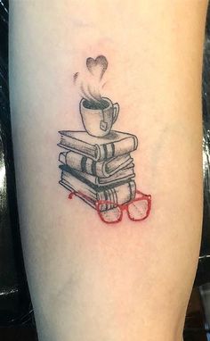 a tattoo with a stack of books and a cup of coffee on top of it