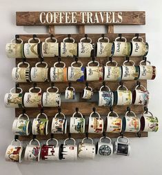 coffee mugs are hanging on a wooden rack