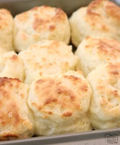 a pan filled with cheese biscuits on top of a table