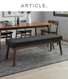 a dining room table with chairs and a bench in front of it that says article