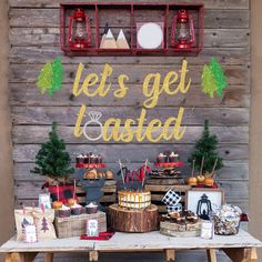 a table topped with cakes and desserts next to a wooden sign that says let's get toasted