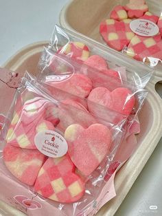 two plastic trays filled with heart shaped cookies