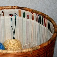 a wicker basket filled with lots of knitting needles