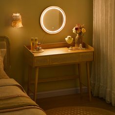 a table with a mirror and flowers on it