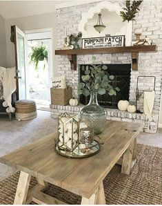 a living room filled with furniture and a fire place in front of a brick fireplace