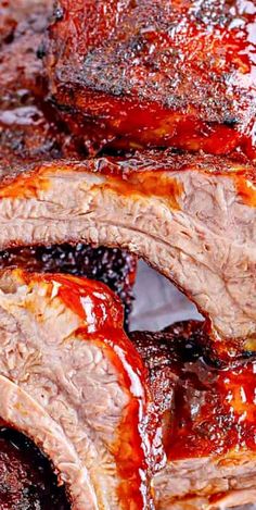 closeup of ribs with bbq sauce on them in a pan, ready to be cooked