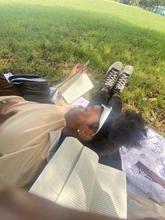 a man laying on the ground reading books