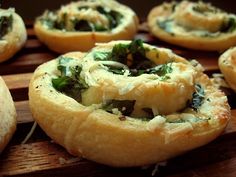 bread with spinach and cheese in it on a wooden tray