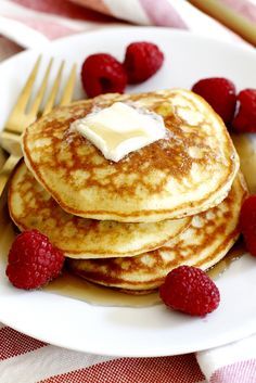 pancakes with butter and raspberries on a plate