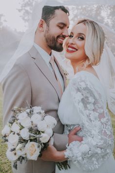 a bride and groom pose for a wedding photo