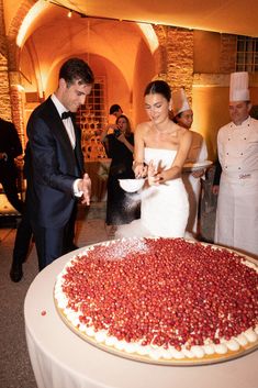 a newly married couple cutting their wedding cake