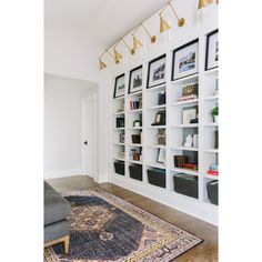 a living room filled with lots of white shelves