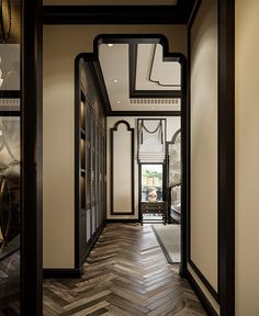 an elegant hallway with wood flooring and black trim