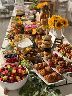 a long table filled with lots of food and desserts on it's sides