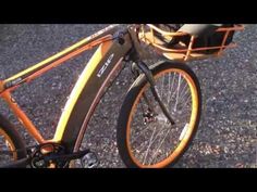 an orange and black bicycle parked on the street