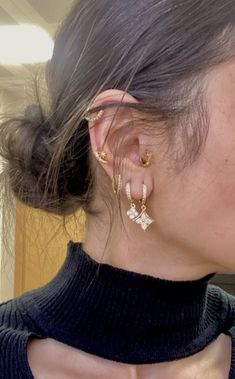 a close up of a person wearing ear clips