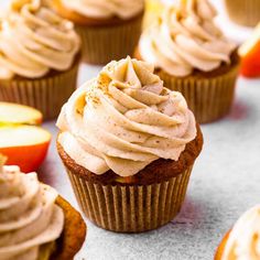 cupcakes with frosting and apples on the side