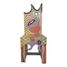 a chair made out of cardboard with an abstract design on the back and sides, sitting in front of a white background