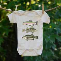 If daddy is a fisherman, chances are your baby will spend some time on the boat. Bring baby to the ocean, lake, or pond with this fun summer body suit! Sizes available include: 0-3M, 3-6M, 6-12M, 12-18M Short or long sleeve styles available! LOOKING FOR DIFFERENT SIZES? Most of our designs are available in 0-3M through Kid's Medium. Use the charts and links below to find your best fit then browse by size! Baby body suits, Sizes Available 0-3M, 3-6M, 6-12M, 12-18M https://www.etsy.com/shop/barefo Summer Fishing Outfit, Fishing Outfit, Summer Bodysuit, Fishing Baby, Outfit Outdoor, Summer Bodysuits, Summer Fishing, Baby Fish, Boy Fishing