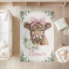 a cow with a pink bow on its head is shown in this baby's room