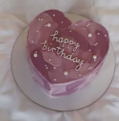 a heart shaped birthday cake with the words happy birthday written on it