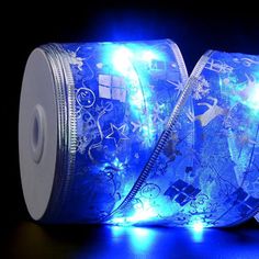 two rolls of blue christmas ribbon with lights on them