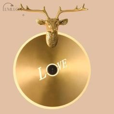 a gold plate with a deer head and the word love on it's side