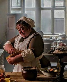 a woman in an old fashioned kitchen preparing food on a wooden cutting board with a measuring spoon