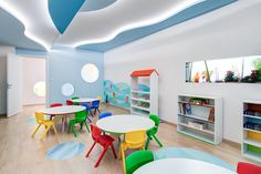 the children's room is brightly decorated with colorful chairs and tables