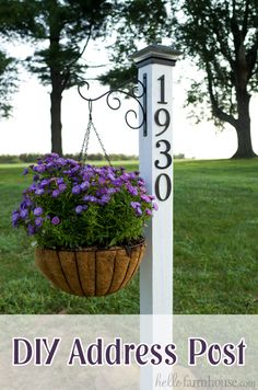 a white post with purple flowers in it and the words diy address post written on it