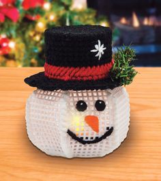 a plastic snowman with a top hat on