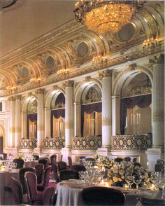 an ornately decorated ballroom with chandeliers and tables