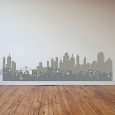 a city skyline wall decal in a room with hardwood flooring and white walls