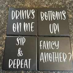 four black coasters with white writing on them