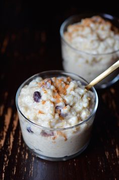 two small bowls filled with oatmeal on top of a wooden table